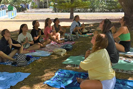 a group of students meditating outside