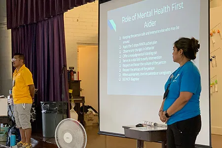 ymca staff giving a presentation on mental health