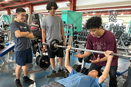 a group of teens working out at the ymca