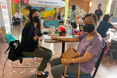 a senior getting a vaccine at a health fair